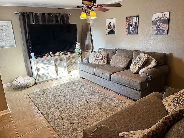 living room with crown molding, ceiling fan, and tile patterned floors