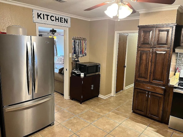 kitchen with ornamental molding, stainless steel appliances, light tile patterned flooring, and dark brown cabinetry