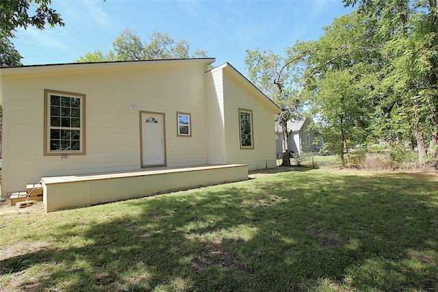 rear view of property with a lawn