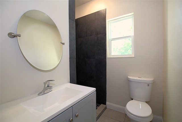 bathroom featuring tile patterned flooring, vanity, and toilet