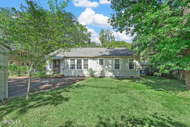 rear view of house with a lawn