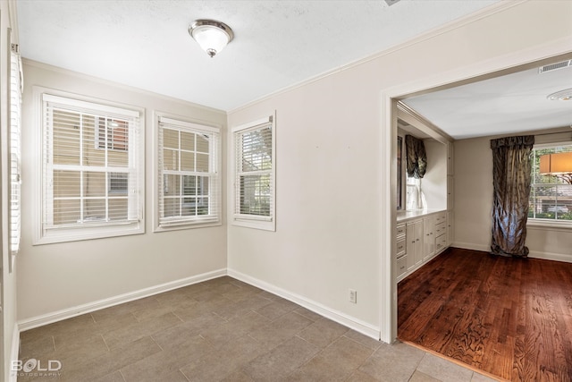 unfurnished room featuring hardwood / wood-style floors and crown molding