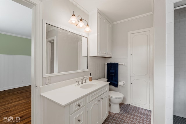 bathroom featuring toilet, vanity, wood-type flooring, and crown molding