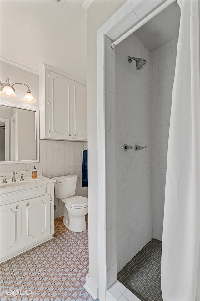 bathroom featuring tile walls, curtained shower, vanity, and toilet