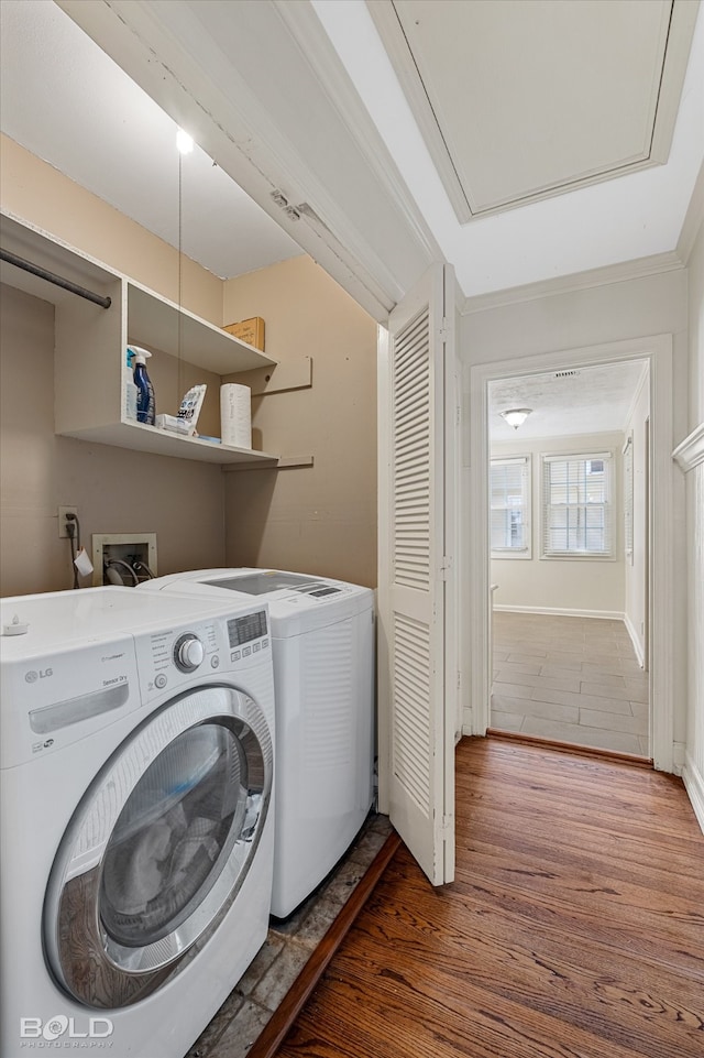 washroom with washer and clothes dryer and hardwood / wood-style floors