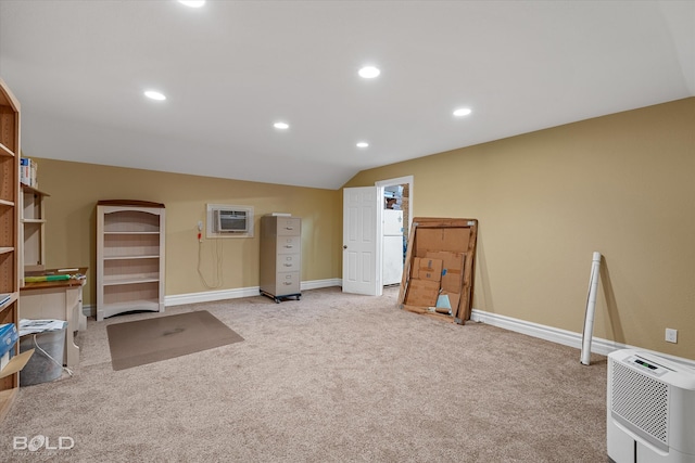 miscellaneous room with light colored carpet, lofted ceiling, and an AC wall unit