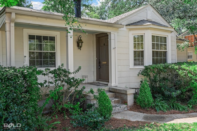 view of exterior entry with covered porch