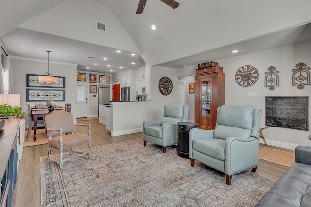 living room with ceiling fan, high vaulted ceiling, and light hardwood / wood-style flooring