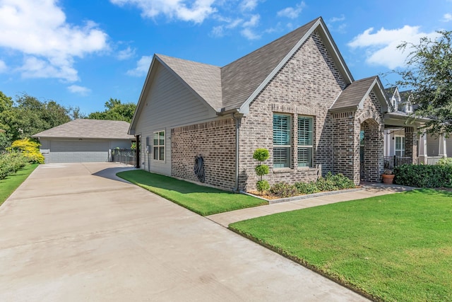 view of front of property with an outdoor structure, a front yard, and a garage