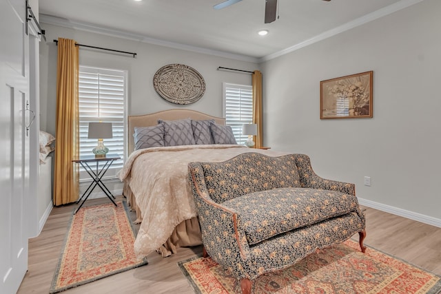 bedroom with ornamental molding, light wood-type flooring, and ceiling fan