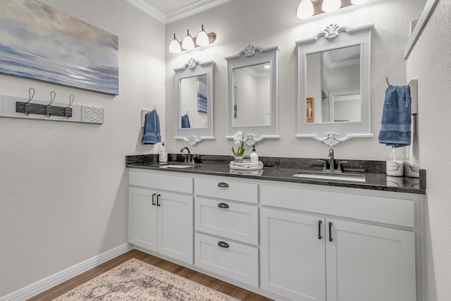 bathroom with vanity, crown molding, and hardwood / wood-style flooring