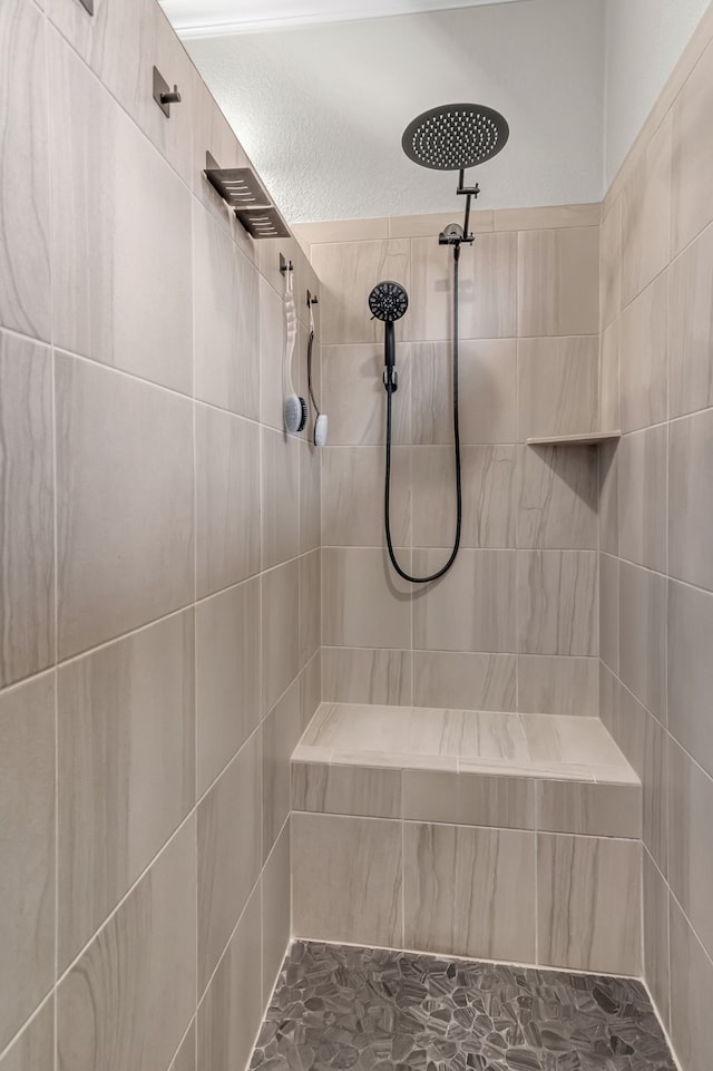 bathroom with tiled shower