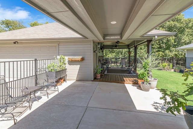 view of patio with a garage and ceiling fan