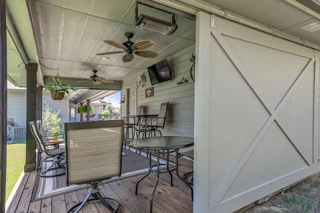 wooden terrace featuring ceiling fan