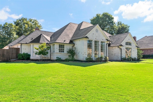 french country style house with a front yard