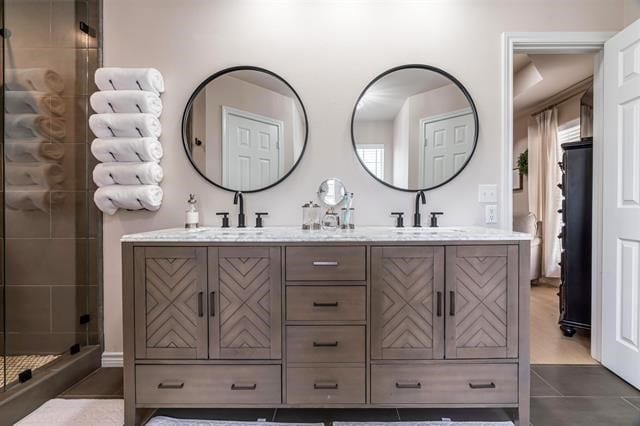 bathroom with vanity, tile patterned flooring, and a shower with door