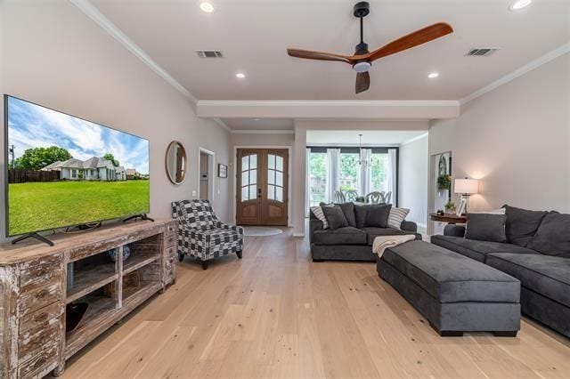 living room with ornamental molding, ceiling fan, light hardwood / wood-style flooring, and french doors