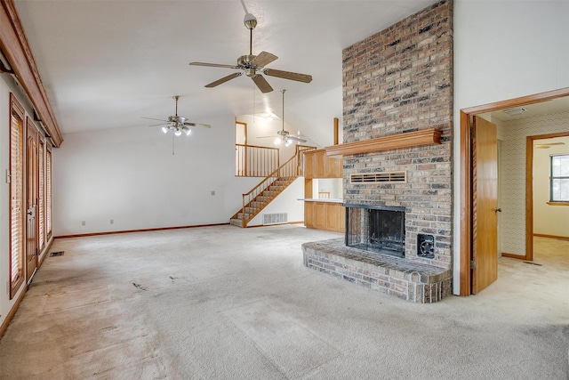 unfurnished living room featuring high vaulted ceiling, light colored carpet, ceiling fan, and a brick fireplace