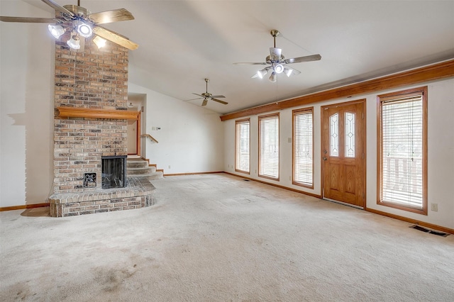 unfurnished living room with a fireplace, lofted ceiling, and light carpet