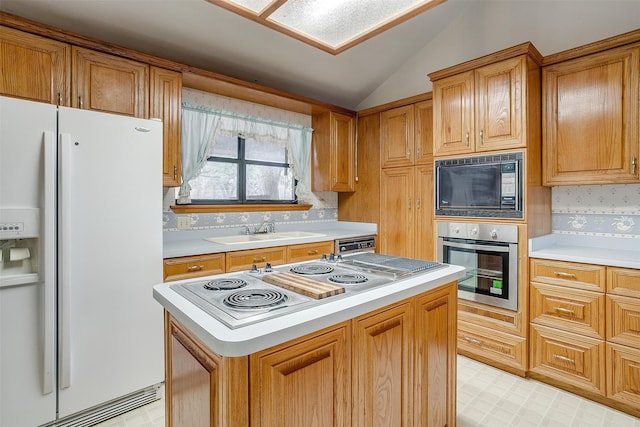 kitchen featuring black microwave, sink, white refrigerator with ice dispenser, stainless steel oven, and vaulted ceiling