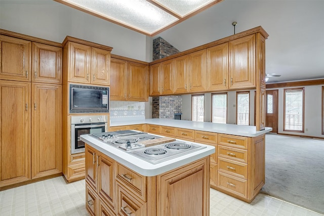 kitchen featuring stainless steel oven, white stovetop, vaulted ceiling, black microwave, and kitchen peninsula