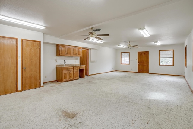 unfurnished living room with ceiling fan