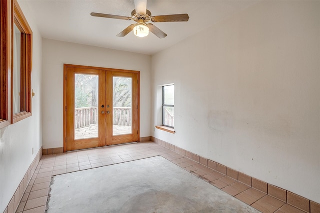 entryway with ceiling fan, light tile patterned floors, and french doors