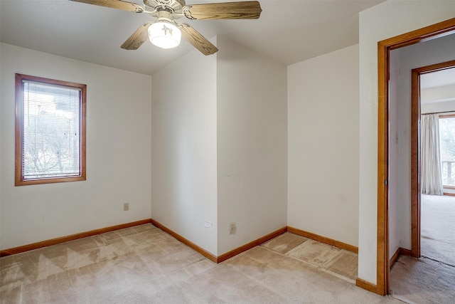 carpeted empty room featuring ceiling fan and vaulted ceiling