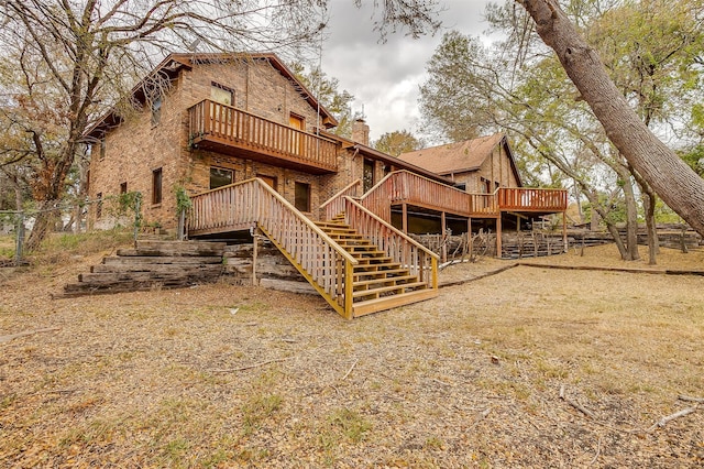 back of house with a deck