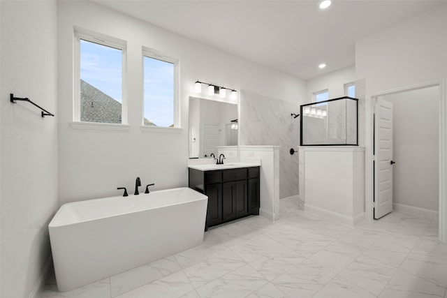 bathroom with vanity and shower with separate bathtub