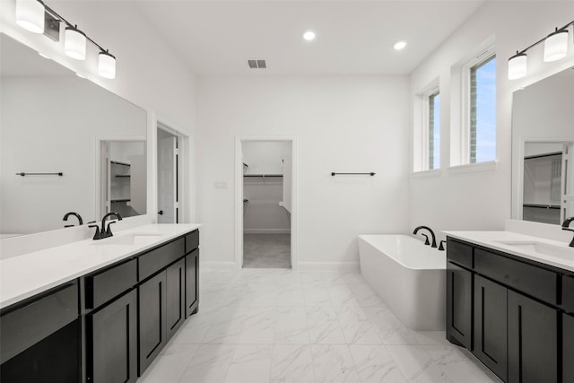 bathroom with vanity and a bathing tub