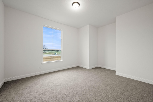 unfurnished room featuring carpet flooring