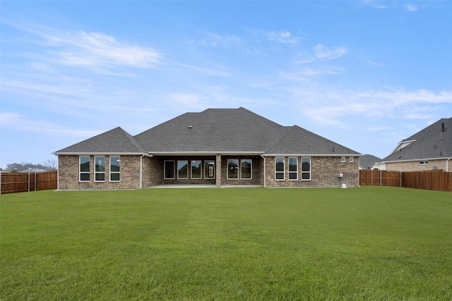 back of house with a lawn