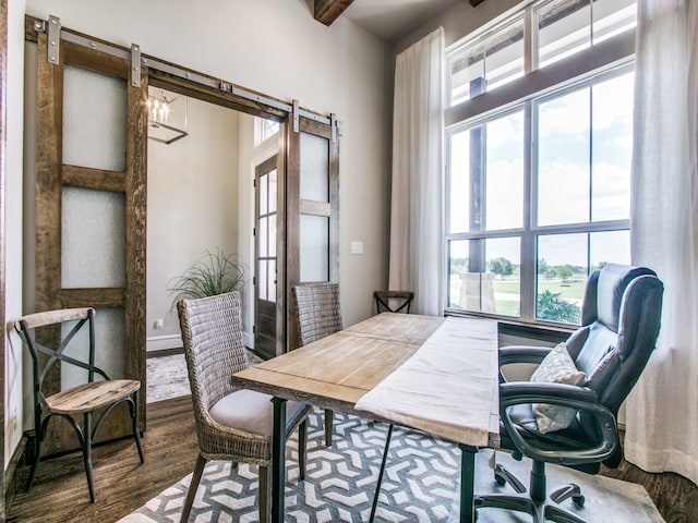 office space with a barn door and hardwood / wood-style floors