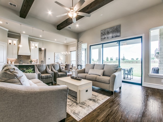 living room with ceiling fan with notable chandelier, dark hardwood / wood-style floors, crown molding, and beam ceiling