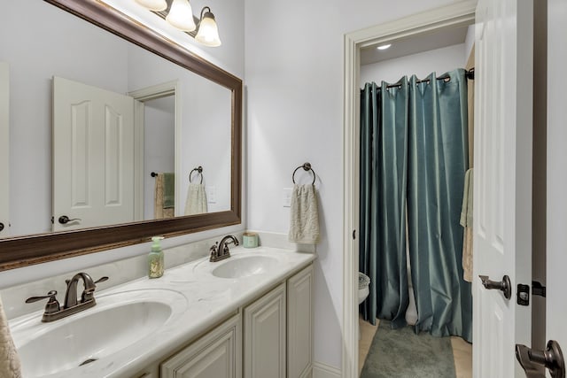 bathroom with vanity, toilet, and tile patterned floors