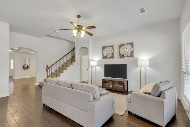 living room featuring ceiling fan and dark hardwood / wood-style floors