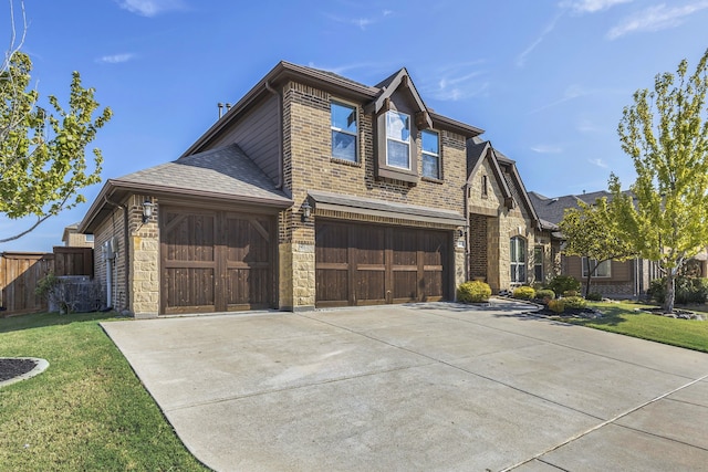 view of front of home with a garage and a front yard