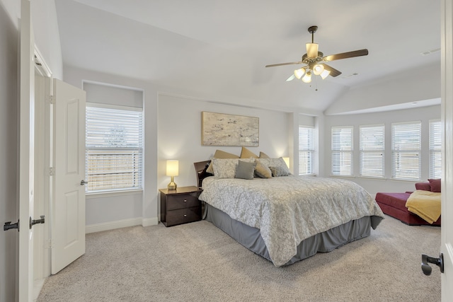 bedroom with lofted ceiling, ceiling fan, and light colored carpet