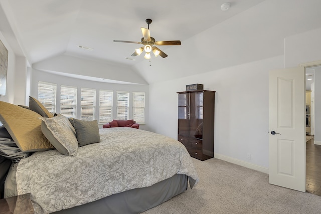 carpeted bedroom with vaulted ceiling and ceiling fan