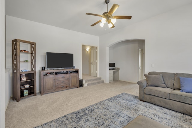 carpeted living room with ceiling fan