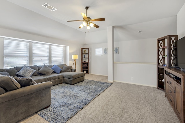 living room featuring lofted ceiling, ceiling fan, light colored carpet, and a healthy amount of sunlight