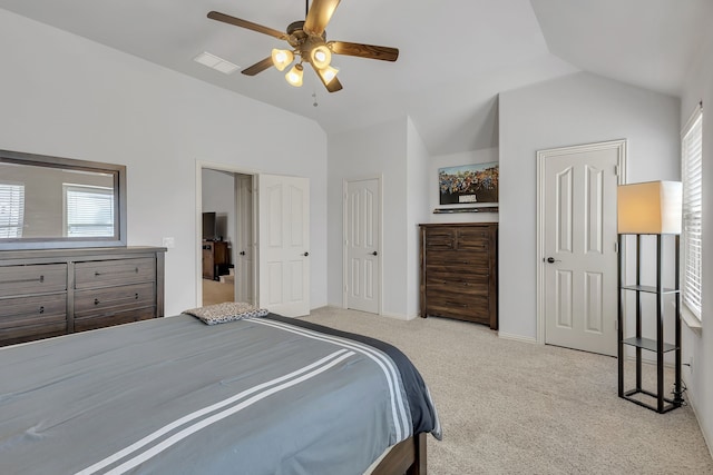 bedroom featuring multiple windows, vaulted ceiling, ceiling fan, and light colored carpet