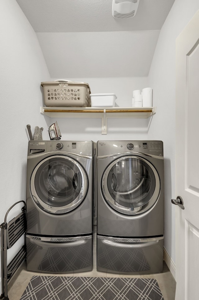 clothes washing area featuring washer and dryer