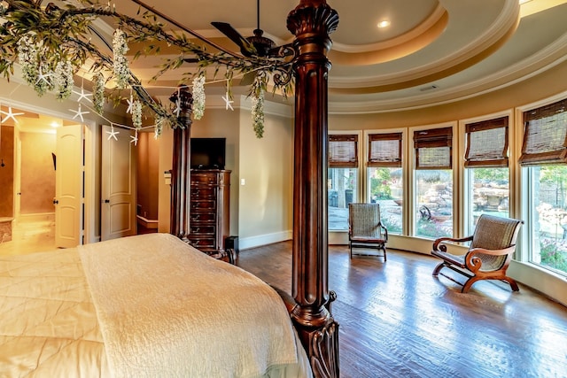 bedroom with ornamental molding and a tray ceiling