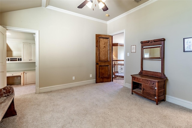 bedroom with ceiling fan, light carpet, ornamental molding, and built in desk