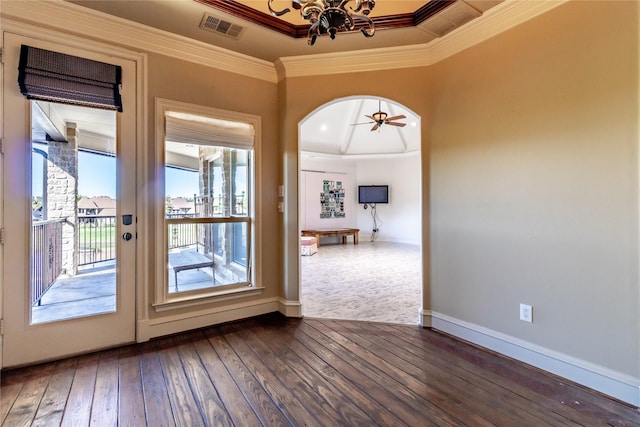 entryway with ceiling fan with notable chandelier, a raised ceiling, crown molding, and dark wood-type flooring