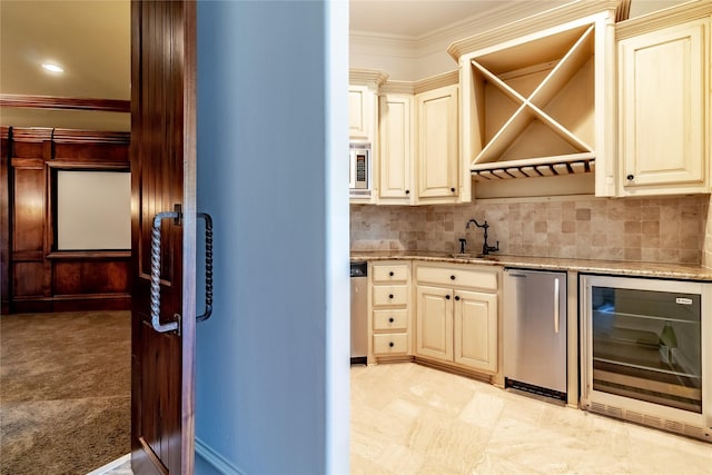 kitchen with wine cooler, sink, cream cabinets, refrigerator, and ornamental molding