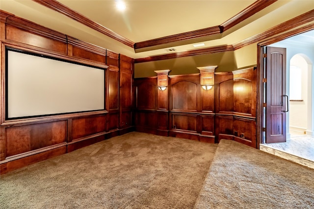 home theater with wood walls, carpet, and ornamental molding