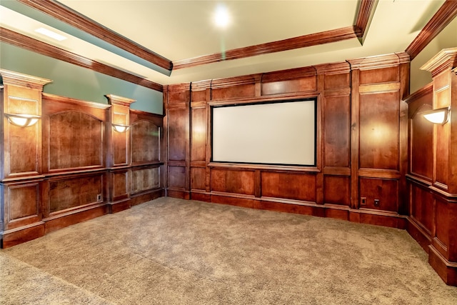 carpeted home theater room featuring wood walls and ornamental molding